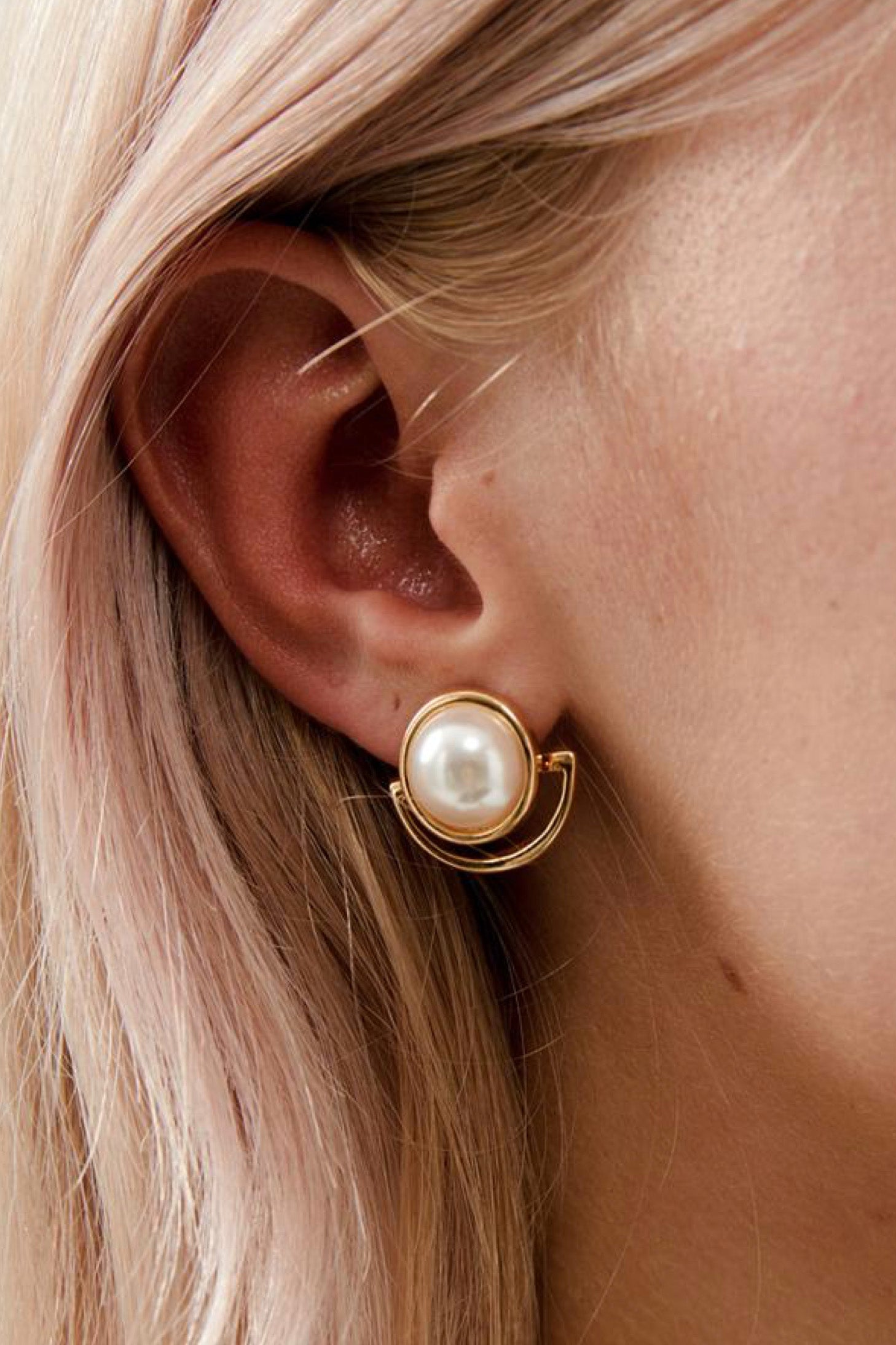 closeup view of Florence Elegant Pearl Stud Wedding Earrings- Gold