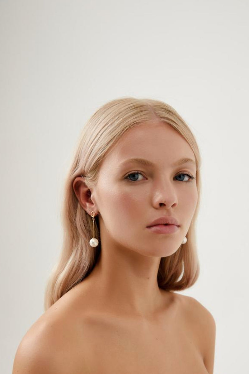 Girl wearing Bella Long Pearl Drop Wedding Earrings- Gold
